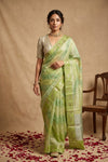 Ganga Ghat ~ Banarasi PureRaw Silk Saree with Silver Zari Stripes and Delicate Floral In Dual - Tone Lime Green - verymuchindian.com