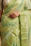 Ganga Ghat ~ Banarasi PureRaw Silk Saree with Silver Zari Stripes and Delicate Floral In Dual - Tone Lime Green - verymuchindian.com